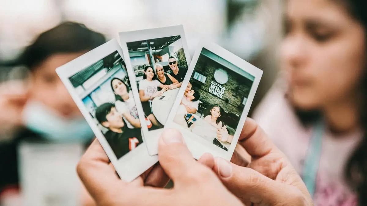 malé fotky z instaxu v rukou nějakého muže malé fotky z instaxu v rukou nějakého muže